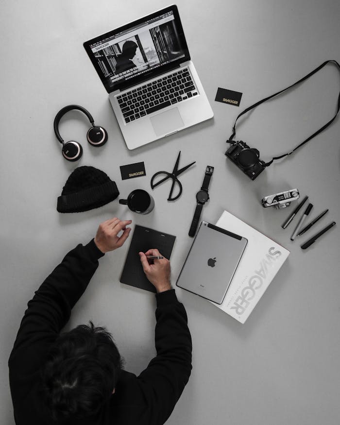 Overhead view of a tech-savvy workspace featuring a variety of gadgets and devices for productivity and creativity.